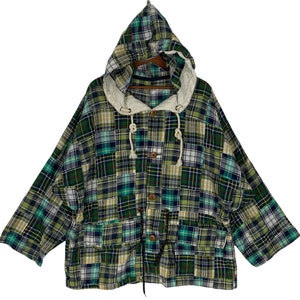 May include: A green, blue, and white plaid hooded jacket with a drawstring closure and multiple pockets.