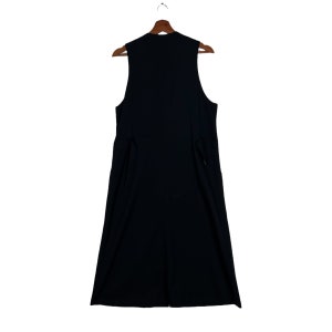 May include: A sleeveless black dress with a V-neckline and a straight skirt.