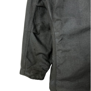 May include: A dark gray jacket with a zipper closure and a seam down the center of the back. The jacket has a slightly textured fabric.