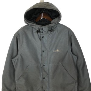 May include: A gray Carhartt hooded jacket with a button front closure and a logo on the chest.
