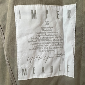 May include: White tag with black text that reads "IMPER 36 Fabriqu&eacute; au Japon Made in Japan Composition: sur &eacute;tiquette s&eacute;par&eacute;e Composition: See attached label Precautions de nettoyage: selon la composition du v&ecirc;tement, voir &eacute;tiquette s&eacute;par&eacute;e. Attention: certains v&ecirc;tements ne peuvent supporter le nettoyage &agrave; sec. Care instructions: Subject to individual item. See attached label for details. Note: some items are not suitable for dry cleaning."  The tag also has a black signature and the word "MEABLE" in black text.