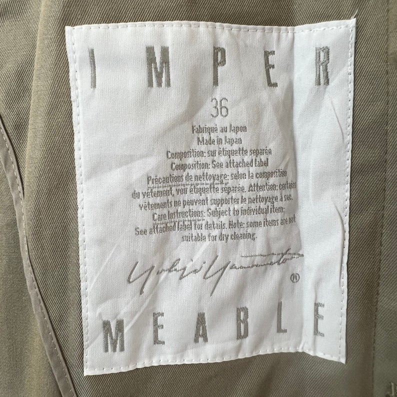 May include: White tag with black text that reads "IMPER 36 Fabriqu&eacute; au Japon Made in Japan Composition: sur &eacute;tiquette s&eacute;par&eacute;e Composition: See attached label Precautions de nettoyage: selon la composition du v&ecirc;tement, voir &eacute;tiquette s&eacute;par&eacute;e. Attention: certains v&ecirc;tements ne peuvent supporter le nettoyage &agrave; sec. Care instructions: Subject to individual item. See attached label for details. Note: some items are not suitable for dry cleaning."  The tag also has a black signature and the word "MEABLE" in black text.