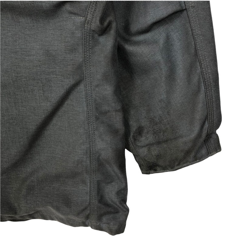 May include: A dark gray jacket with a zipper closure and a quilted design. The jacket has a seam down the side and a ribbed cuff.