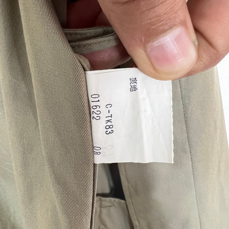May include: A close-up of a beige fabric tag with the text "C-TK83 01622 0B" and the word "製造" in Japanese characters.