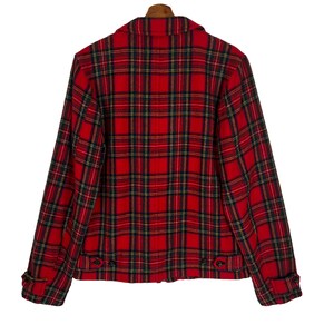 May include: Red and black plaid jacket with a zipper closure and button accents. The jacket has long sleeves and a collar.