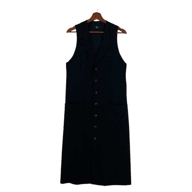 May include: A long black sleeveless vest with a button-up front and two pockets. The vest has a Y.Y. label on the inside.