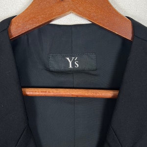 May include: A black blazer with a Y's label on the inside.