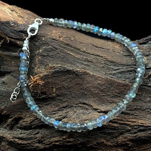 May include: A silver chain bracelet with iridescent blue labradorite beads.