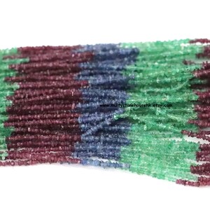 May include: A strand of faceted gemstone beads in shades of green, blue, and purple. The beads are small and uniform in size, and they are strung together on a clear thread. The beads are arranged in a multi-colored pattern, with the green beads at the top, the blue beads in the middle, and the purple beads at the bottom. The beads are all faceted, which gives them a sparkling appearance. www.multistonehousehk.etsy.com