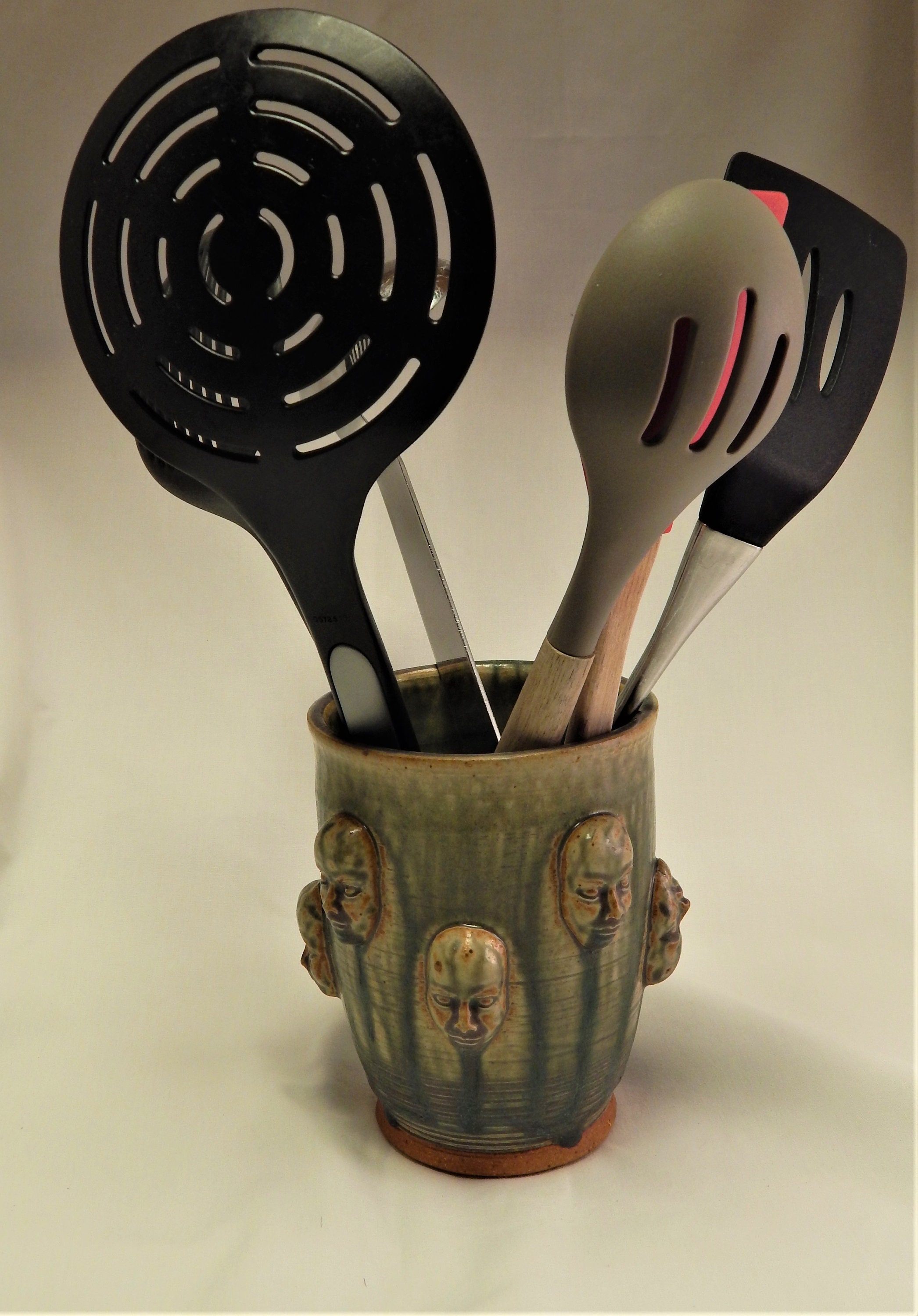 Green Utensil Holder with Faces