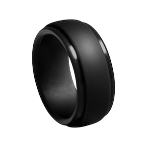 May include: A black silicone ring with a smooth, matte finish. The ring has a beveled edge and a slightly raised center.