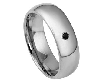 May include: A silver wedding band with a single black diamond set in the centre.