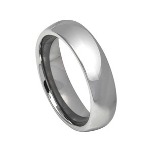 May include: A silver wedding band with a smooth, rounded surface.