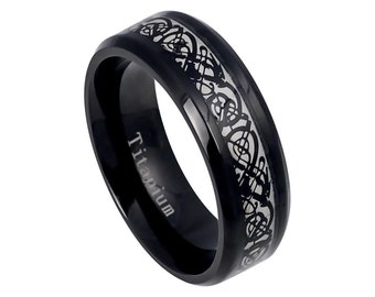 May include: Black titanium ring with a silver Celtic knot design. The ring is engraved with the word "Titanium".