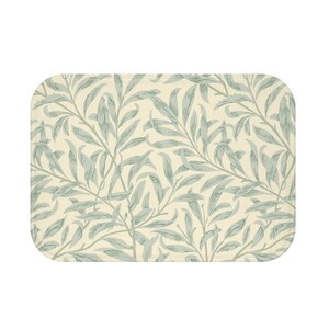 May include: A rectangular bath mat with a cream background and a repeating pattern of green willow leaves.