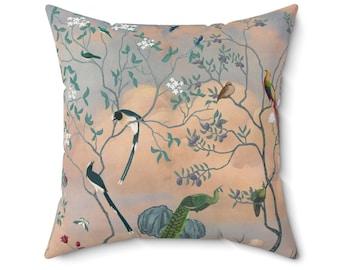 May include: A decorative throw pillow with a peach background featuring a stylized illustration of a tree with birds and a peacock. The tree has green leaves and white flowers. The birds are blue, green, brown, and red.