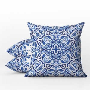 May include: Two blue and white patterned throw pillows with a geometric design. The pillows are made of a soft, comfortable fabric and are perfect for adding a touch of style to any room.