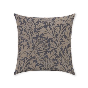 May include: A square throw pillow with a dark blue background and a beige floral pattern. The pattern features stylized leaves and flowers.