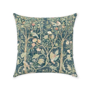 May include: A square throw pillow with a dark blue background featuring a repeating pattern of stylized trees, birds, and flowers. The design is reminiscent of a tapestry or embroidery.