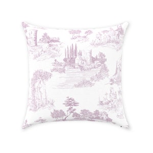 May include: Square throw pillow with a white background and a lavender toile pattern. The pattern depicts a scenic landscape with castles, trees, and figures. The pillow is a decorative home accent.