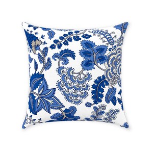May include: Square throw pillow with a white background and a repeating floral pattern in shades of blue and gray. The design features large, stylized flowers and leaves.