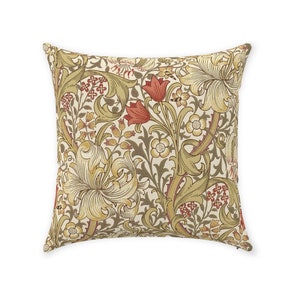 May include: Square throw pillow with a floral pattern in shades of cream, gold, red, and brown. The design features stylized flowers and foliage, creating a vintage aesthetic. The pillow is likely made of a soft fabric.