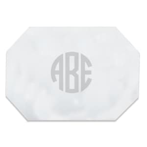 May include: White octagon-shaped placemat with a silver monogram of the letters "ABE" in a circle.