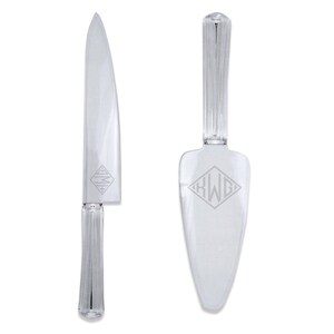 May include: A clear plastic cake knife and server set with engraved monograms "KWG" and "AMM".