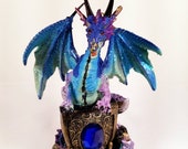 Blue Dragon Holding Shield With Gem on a Rock Collectible