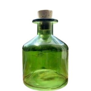 May include: A green glass bottle with a cork stopper. The bottle is empty and has a rounded shape.