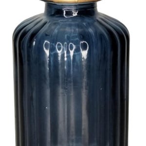 May include: A dark blue glass vase with a gold rim. The vase has a ribbed design and is perfect for displaying flowers.