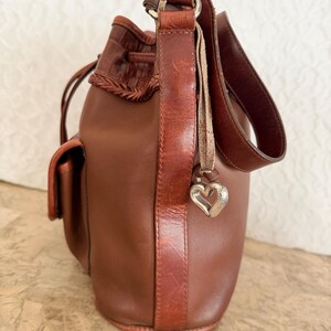 May include: A rustic wooden sign with the text "Welcome to our home" in white lettering. The sign features a distressed finish and a simple, inviting design, perfect for entryway decor.