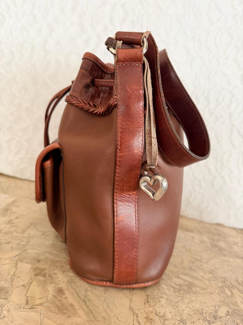 May include: A rustic wooden sign with the text "Welcome to our home" in white lettering. The sign features a distressed finish and a simple, inviting design, perfect for entryway decor.