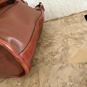 May include: A set of three ceramic mugs with a speckled, matte finish. The mugs are in shades of cream, light gray, and dark gray. Each mug has a simple, minimalist design, perfect for coffee or tea.