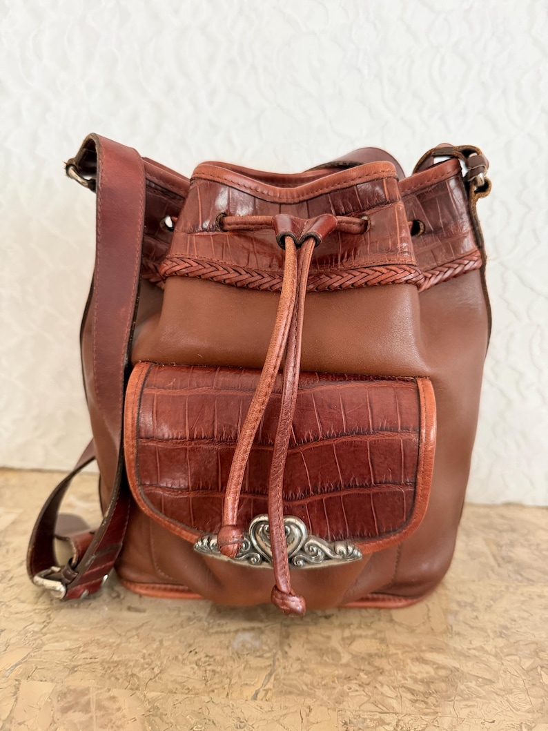 May include: A set of three ceramic mugs with a speckled, matte finish. The mugs are in shades of cream, light gray, and dark gray. Each mug has a simple, minimalist design, perfect for coffee or tea.