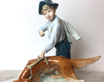 Vintage Royal Dux figurine. This vintage figurine is a boy with dog.  This dog figurine is the perfect dog gift or golden retriever gift!