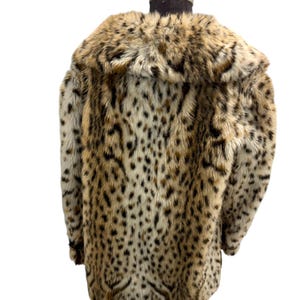 May include: A brown and white leopard print faux fur coat with a large collar.