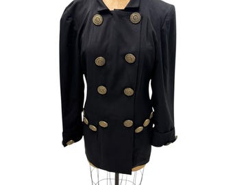 May include: A black double-breasted jacket with gold-toned buttons. The jacket has a slightly fitted silhouette and long sleeves.