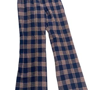 May include: Blue and tan plaid pants with a wide leg.