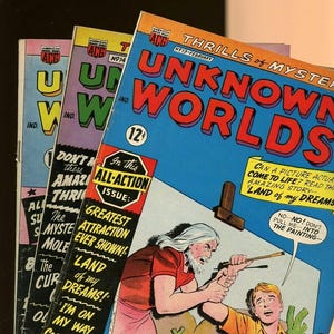 May include: A stack of three vintage American Comics Group comic books titled Unknown Worlds. The top issue features a colorful cover illustration of a bearded person pulling a younger person toward a painting, with text including 12 cents price.