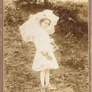 Girl with Parasol (Umbrella) Wearing Stockings and Holding Flowers. Great Vintage Black and White Photograph from Standard Photo Company.