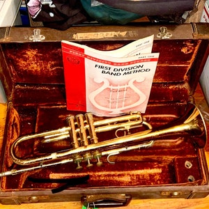 Trumpet w case and instructional book 1968. Vintage Olds Ambassador.  Polish it up to play, as prop or display Dizzy Gillespie Tix Available