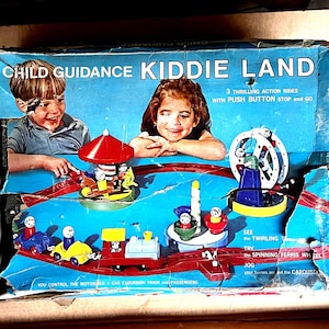 May include: Vintage Child Guidance Kiddie Land toy set. The box features illustrations of children and the text "Child Guidance Kiddie Land". The set includes a red track with various amusement park rides, including a carousel and a Ferris wheel.