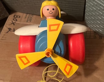 Fisher Price Airplane pull toy with a blond headed piolet and a fast spinning propeller when the toy is pulled! Vintage 1980 Pull Toy.