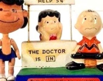 Peanuts Gang Vintage 1952-1971 Psychiatrist Lucy and Charlie Brown Doctor is in Help 5 cents 1971,  Walking Lucy 1968, Lucy Figure 1952.