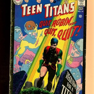 May include: Vintage Teen Titans comic book cover. The cover features the title "Teen Titans" in large red letters, with the words "Quit Robin... Quit, Quit!" below. The artwork depicts Robin standing in a graveyard, with other characters in the background. The comic is marked "No. 14" and "Apr".