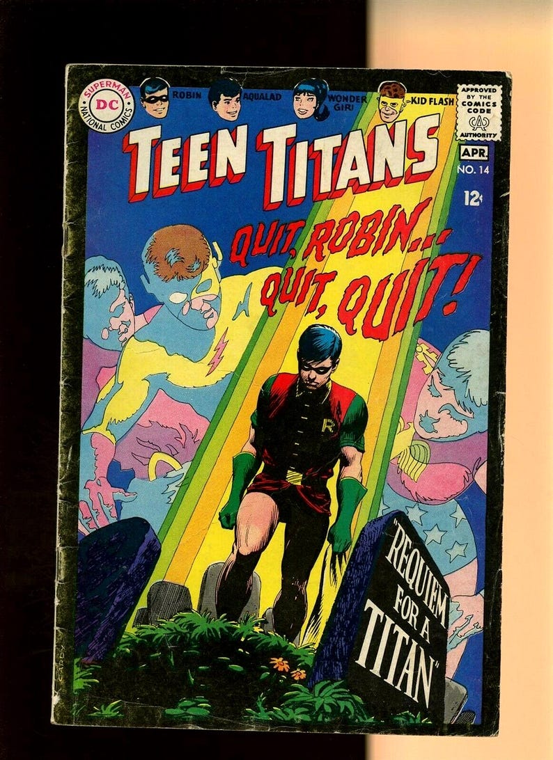 May include: Vintage Teen Titans comic book cover. The cover features the title "Teen Titans" in large red letters, with the words "Quit Robin... Quit, Quit!" below. The artwork depicts Robin standing in a graveyard, with other characters in the background. The comic is marked "No. 14" and "Apr".