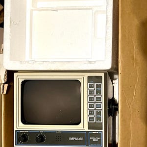 May include: An Impulse Micro-Trac 6800 fish finder with a beige casing and a black screen. The device features a control panel with buttons labeled Zoom, Depth Alarm, Range, Speed Reset, and Deep Alarm, plus knobs for brightness, gain, and alarm.
