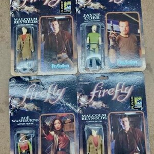 May include: Four action figures from the TV show Firefly, packaged in cardboard boxes with the show's logo and character names. The figures are of Malcolm Reynolds, Jayne Cobb, Zoe Washburne, and Malcolm Reynolds.