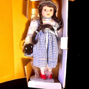 Wizard of Oz Dorthey Doll with her little dog Toto too in the Ruby Red Slippers. Great new in the box  vintage condition with stand!